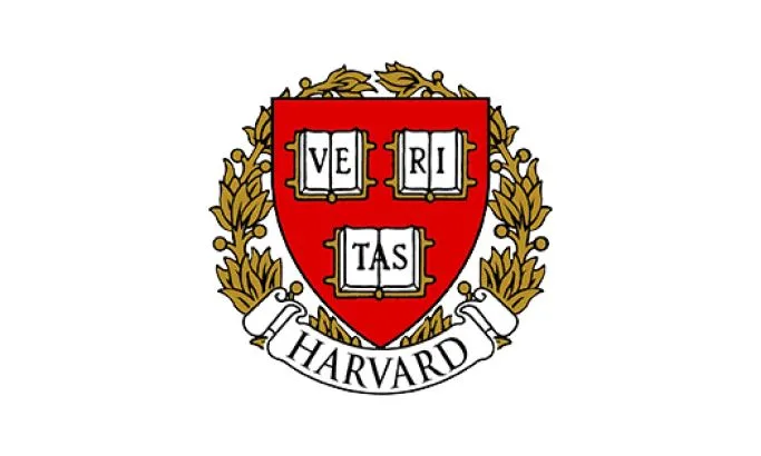 Harvard crest in gold, red, and white, with Veritas spelled out on the shield